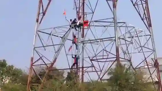 Why did farmers climb mobile towers?
